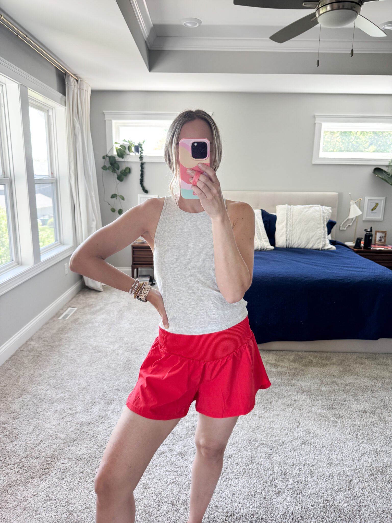 Vuori gray ribbed tank with Target red athletic shorts, styled for a lightweight, warm-weather jog.