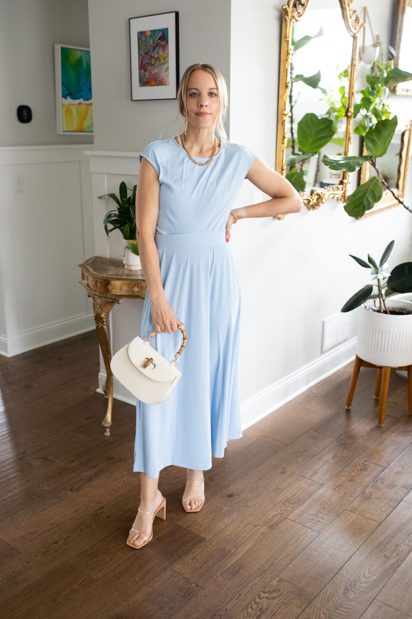 2-piece set featuring a short sleeve crop top and high waist midi skirt in a soft, breathable knit fabric, styled with strappy sandals.