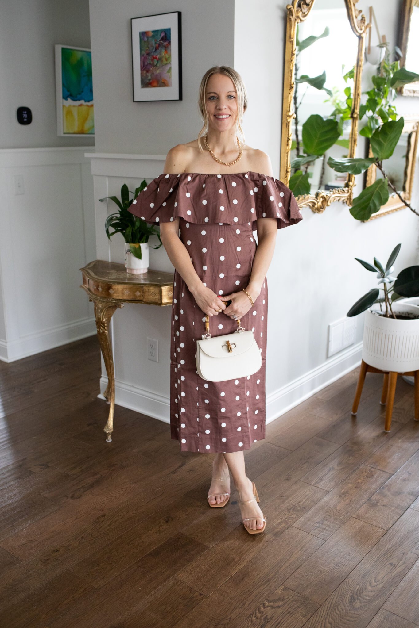 Brown polka dot strapless ruffle midi dress with a smocked back and center slit, perfect for a barn wedding or outdoor event.