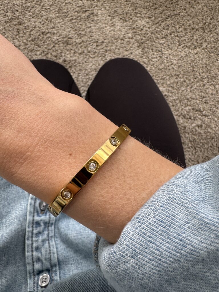 A close-up of the PDWZNBA 18K Gold Plated Love Friendship Bracelet featuring CZ stones, worn on a wrist