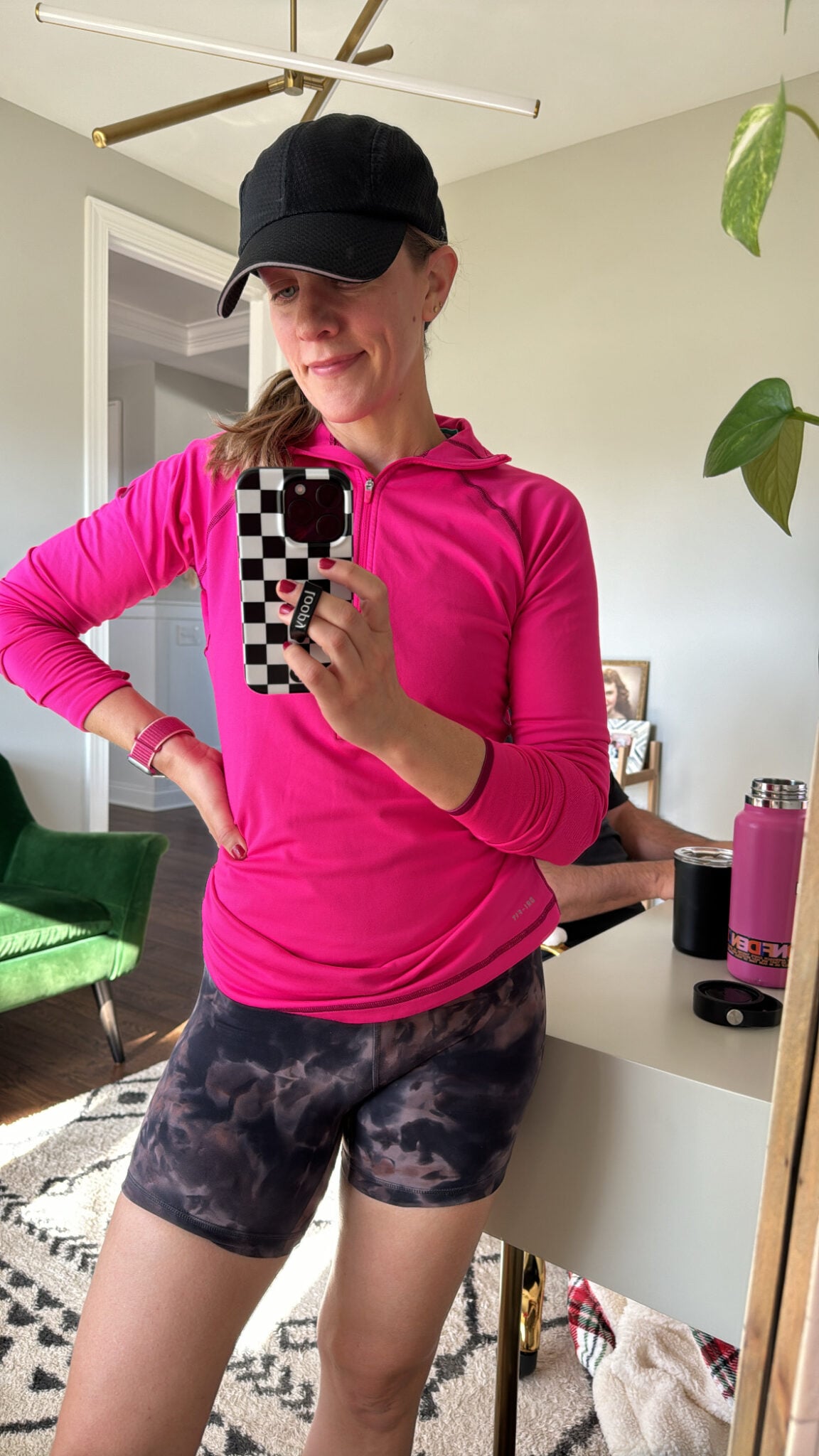 Jen wearing a lightweight, breathable cap, with a hot pink long sleeve dry fit and 6" shorts