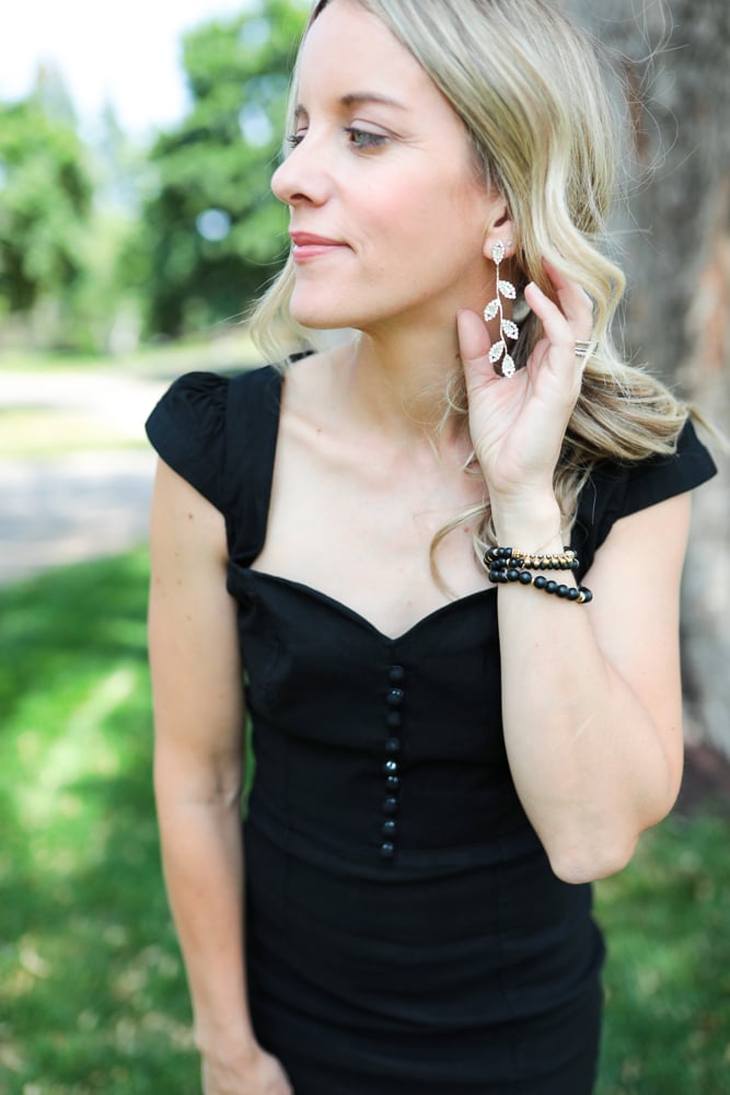 Jen wearing silver rhinestone leaf drop earrings