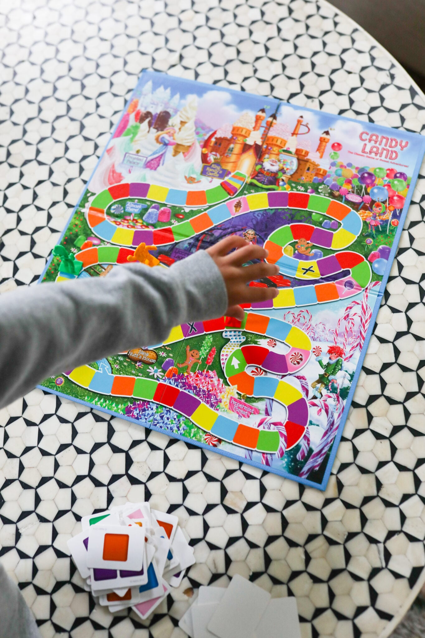Kids playing Candy Land at a table, colorful game board and cards in view. ( Screen-Free idea )