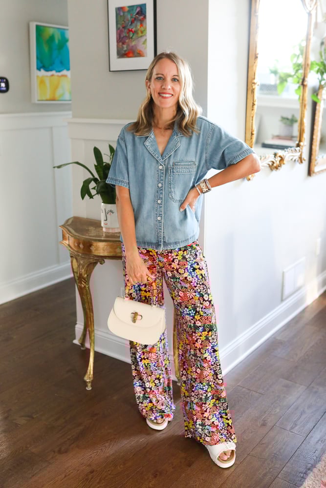 Denim button-down shirt and pants paired with Birkenstocks and a top-handle bag.