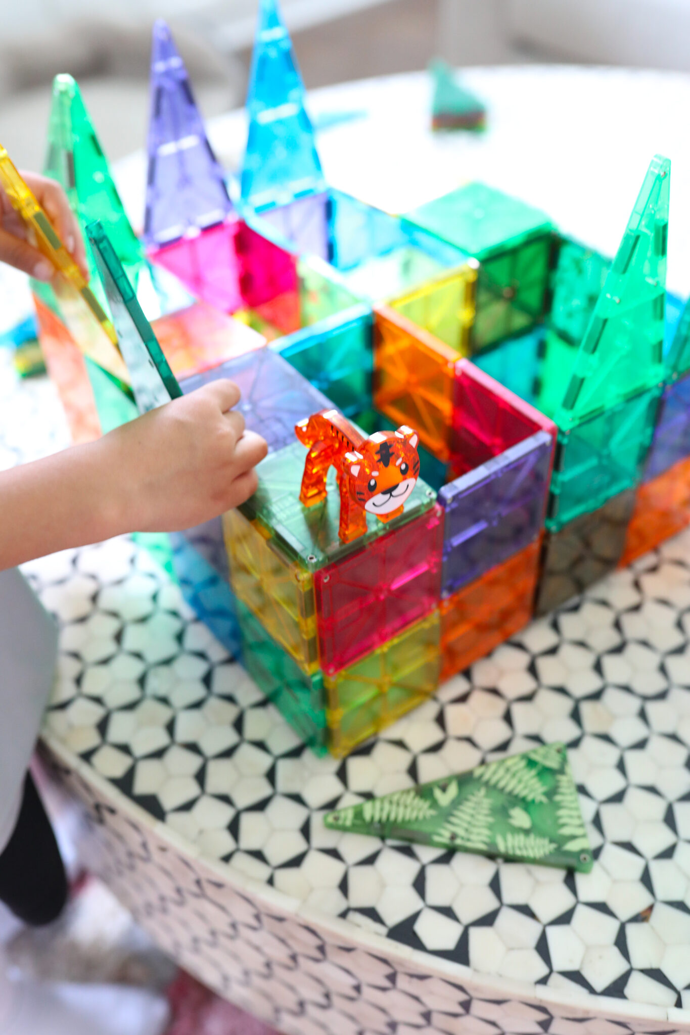 Kids building colorful Magna-Tiles structures on table ( Screen-Free idea )