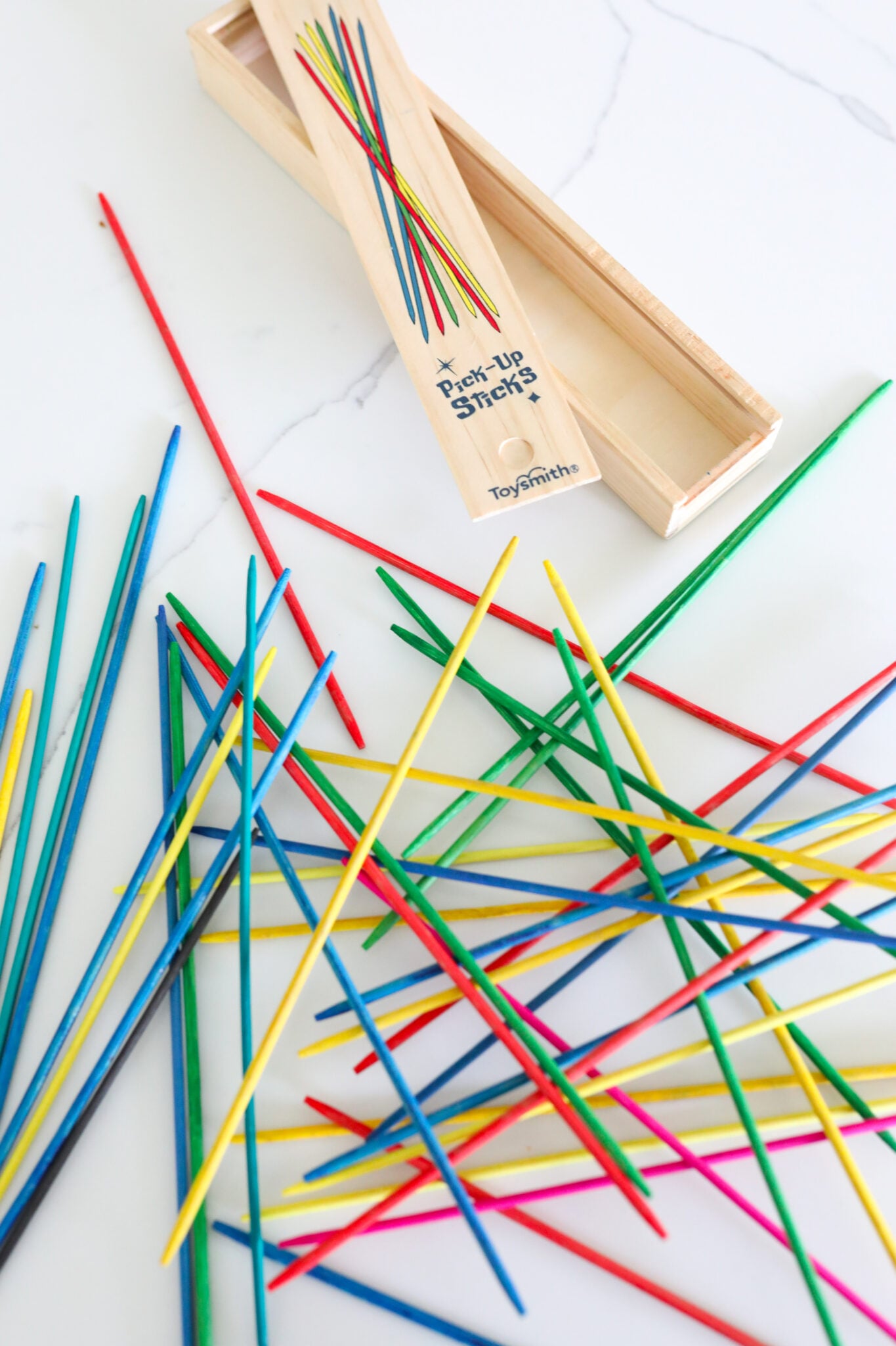 Colorful pick-up sticks spread out on table ( Screen-Free idea )