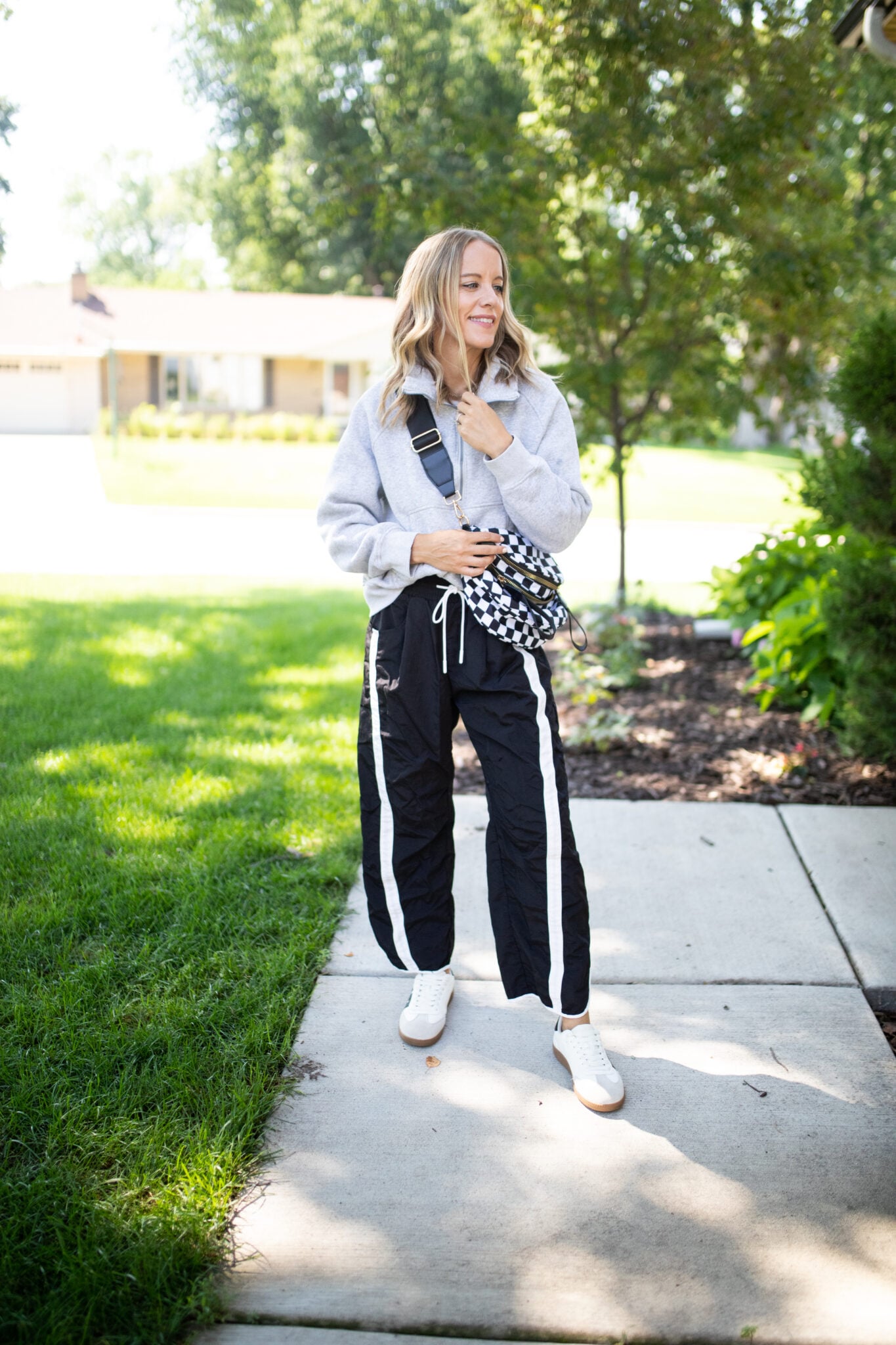 Wide-leg drawstring pants styled with a Vuori sweater and sneakers for a cozy, casual fall outfit.