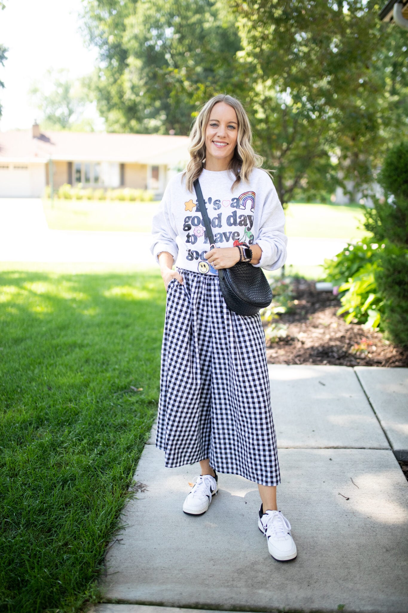 Gingham pants styled with a chunky sweater and sneakers for a casual fall look.