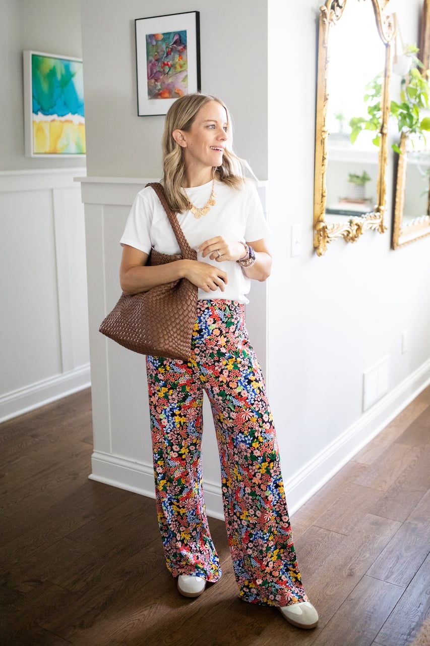 woman in floral pants and white shirt.