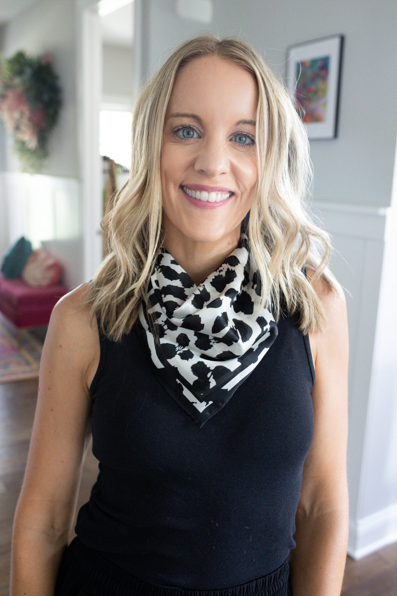 Jen Paisley of Paisley and Sparrow styling a black tank top outfit accessorized with a black and white leopard print neck scarf from Target, perfect for casual chic looks.