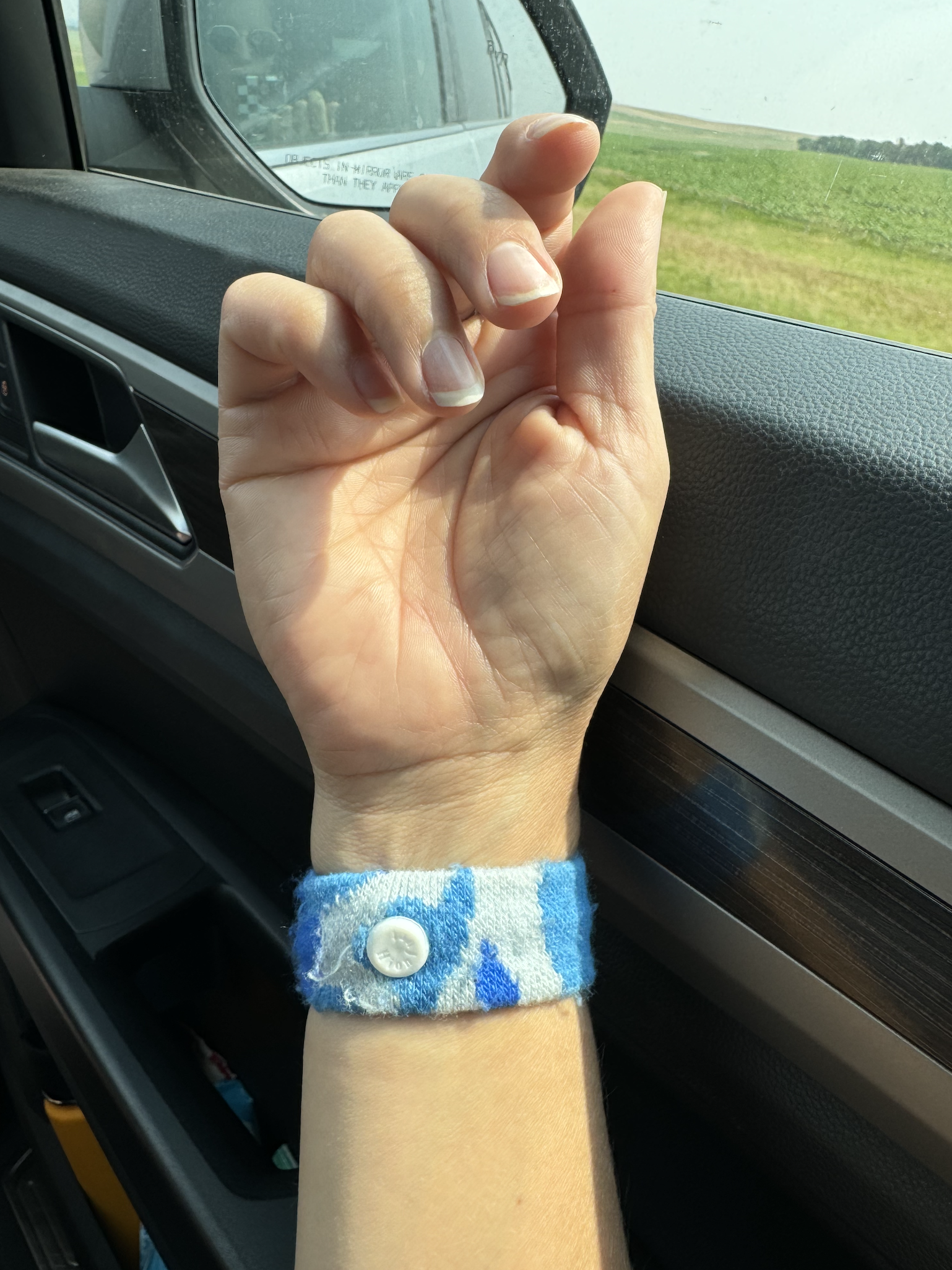 Motion sickness wrist band in neutral color shown close up