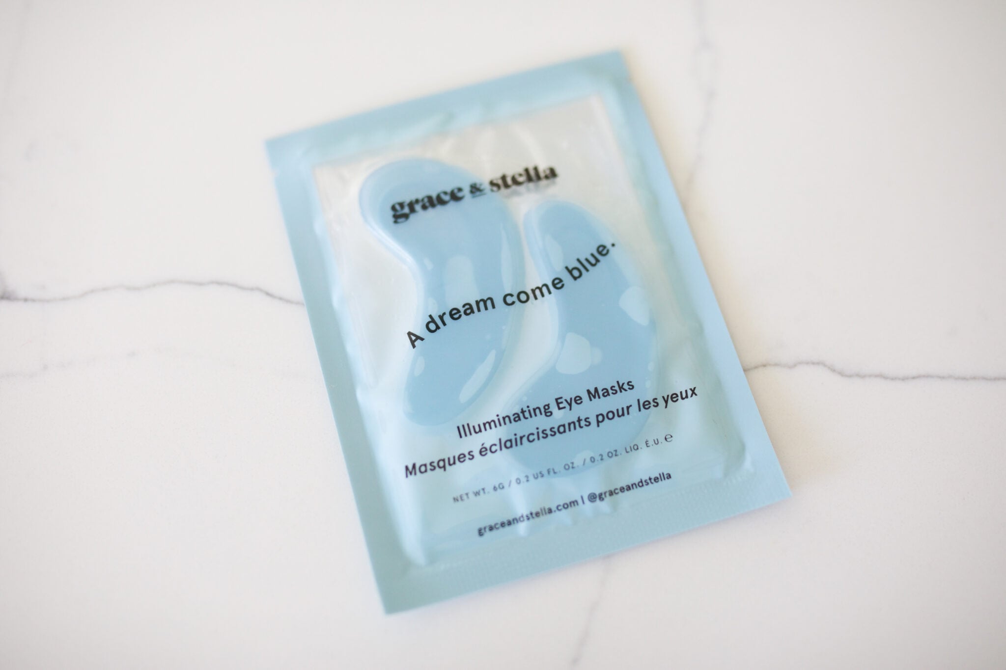 Grace and Stella illuminating blue eye masks in travel size packaging