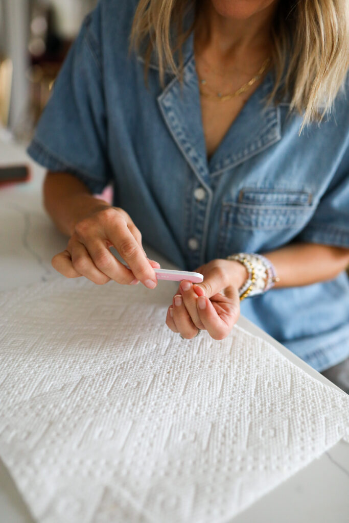 A woman filing her nails.