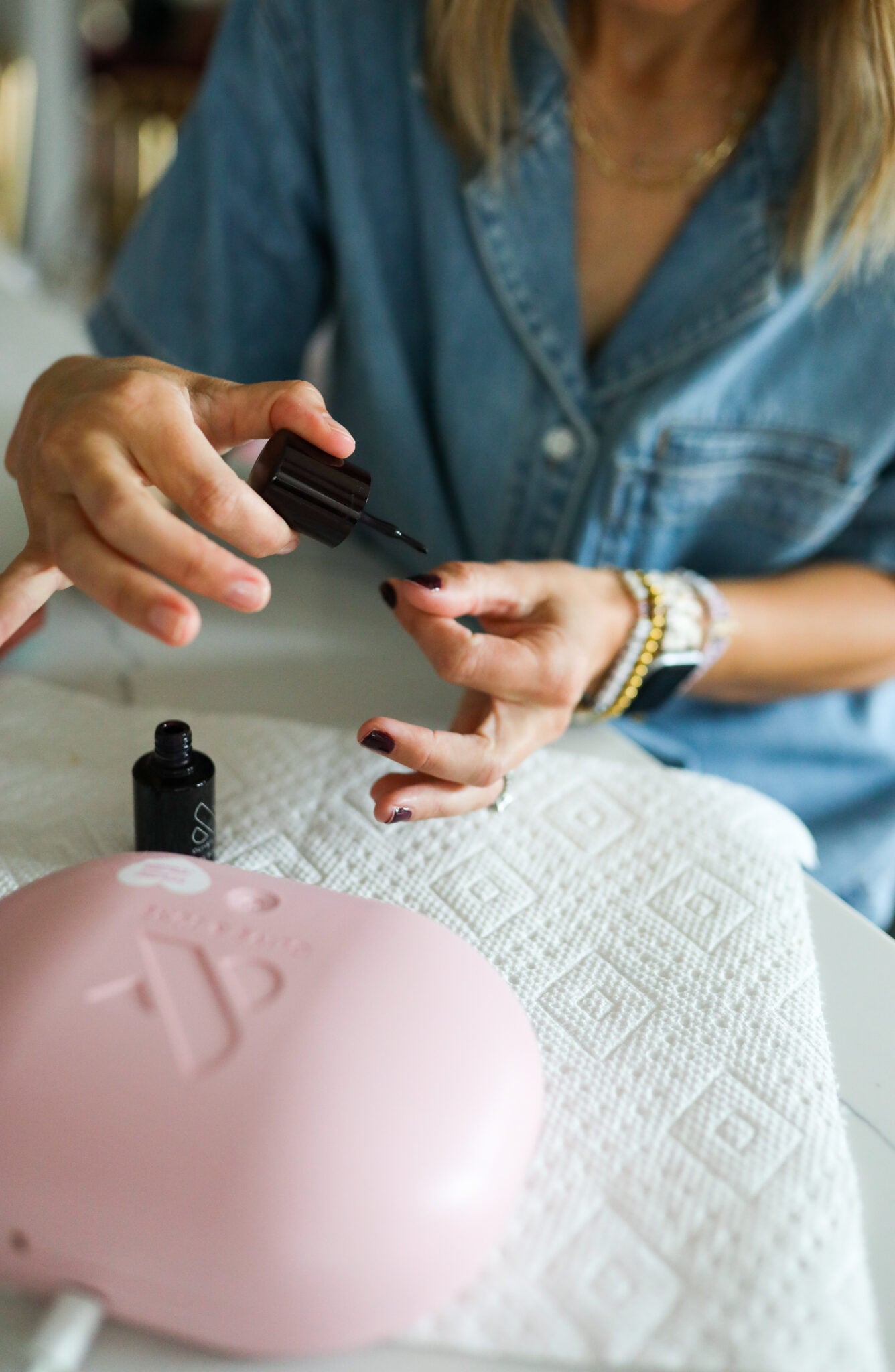 A woman painting her nails.