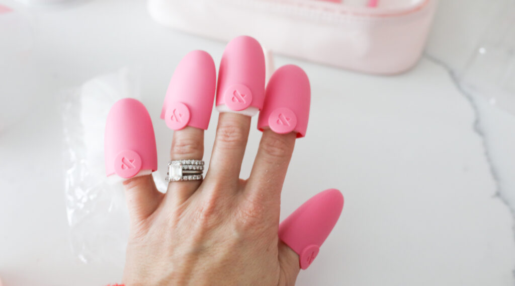 A woman removing gel nails.