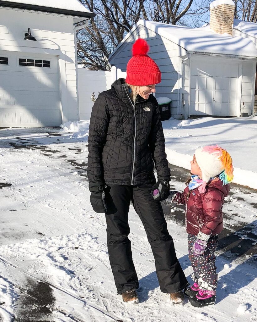 Mom and daughter outside in the snow