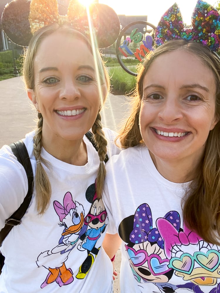 Two women wearing minnie mouse and Daisy Duck shirts