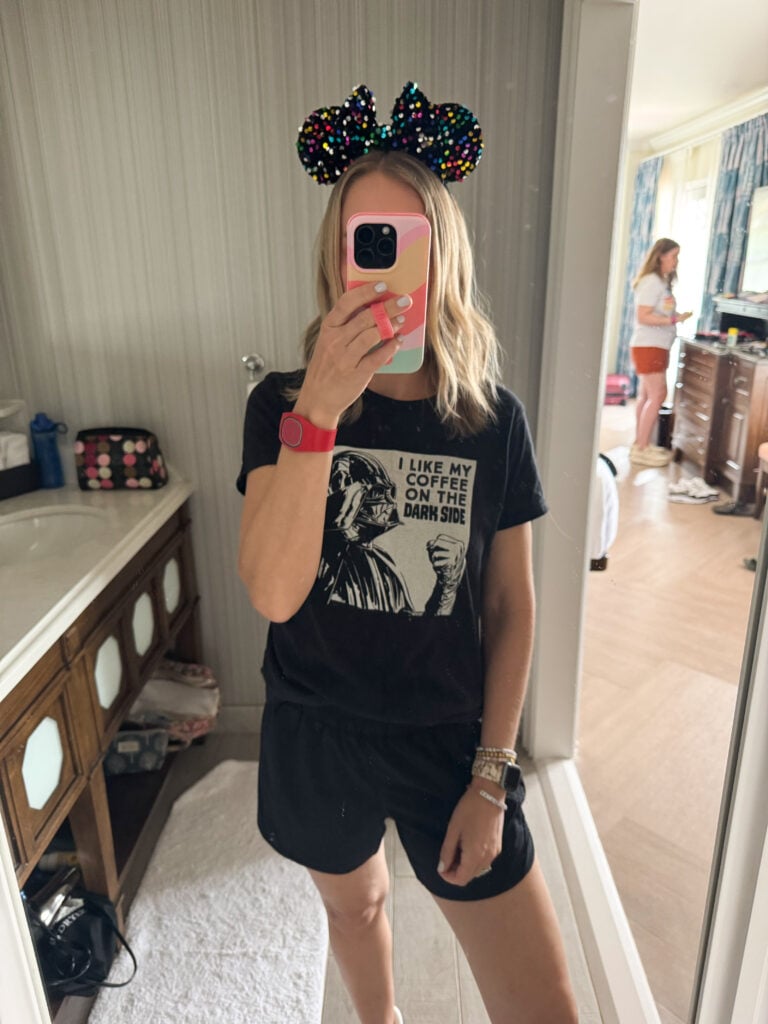 A woman wearing a funny Darth Vader "I like my coffee on the dark side" shirt