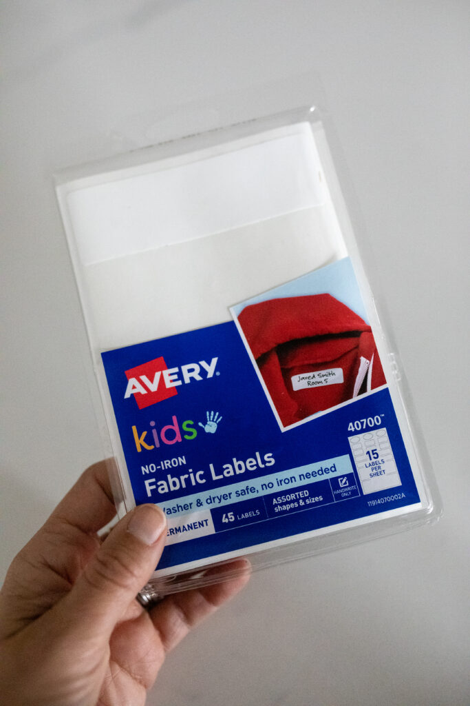 woman's hand holding a package of fabric labels