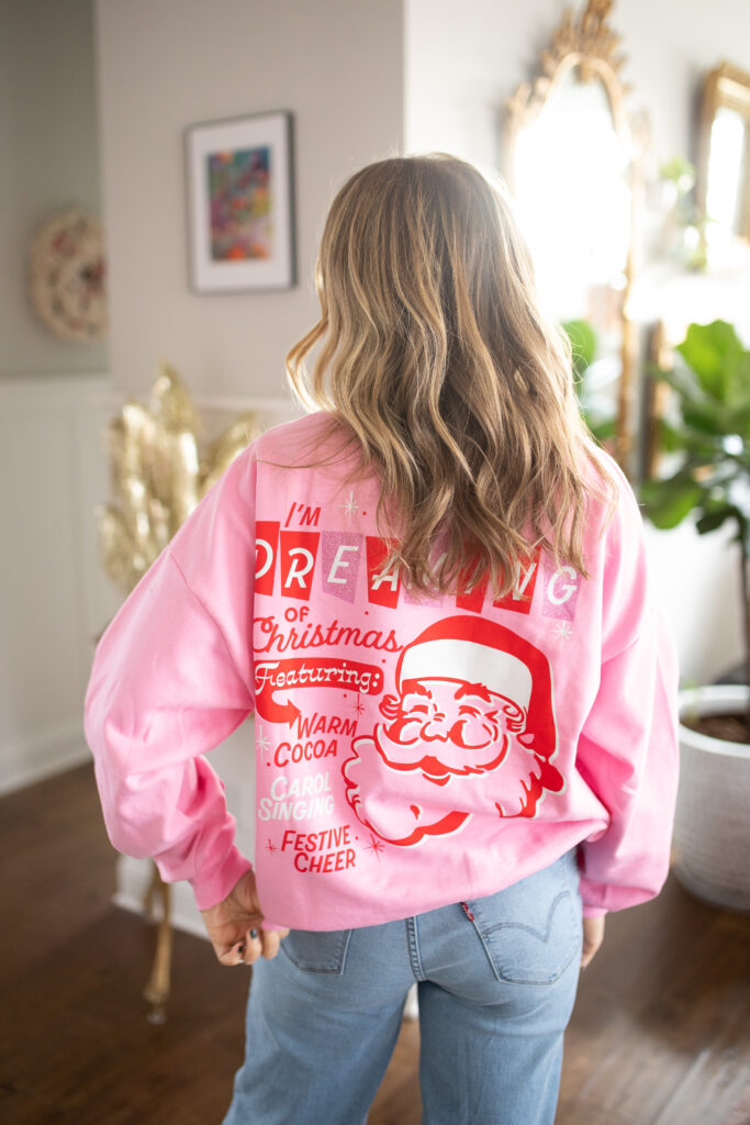 Pink christmas sweater with Santa on the back