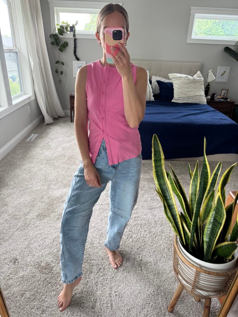Woman in barrel jeans and pink top